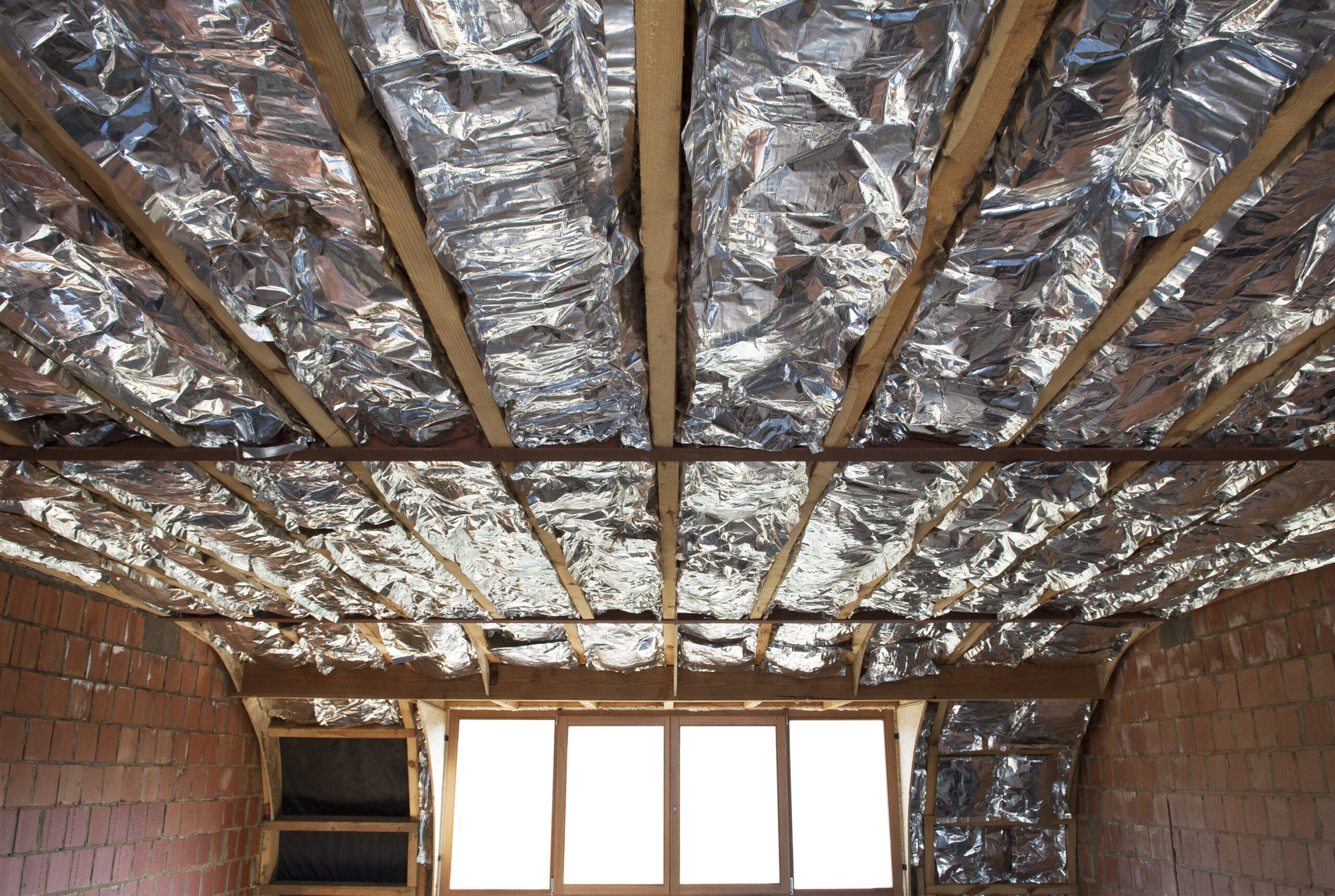 construction of the wooden frame of a roof Fibrerglass insulation installed in the sloping ceiling of a house. Construction of Drywall-Plasterboard Before and after